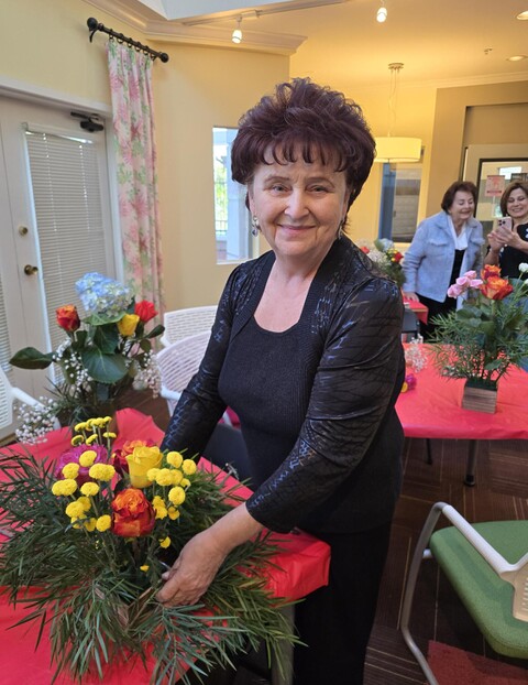 Laurel Norton resident with flower arrangements